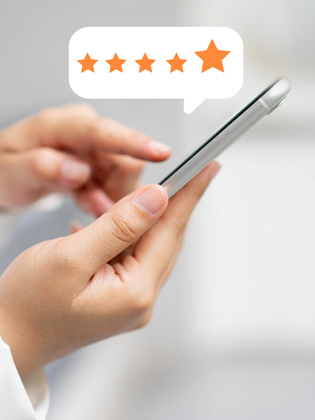 Person holding smart phone leaving a 5 Wells Trust Google review