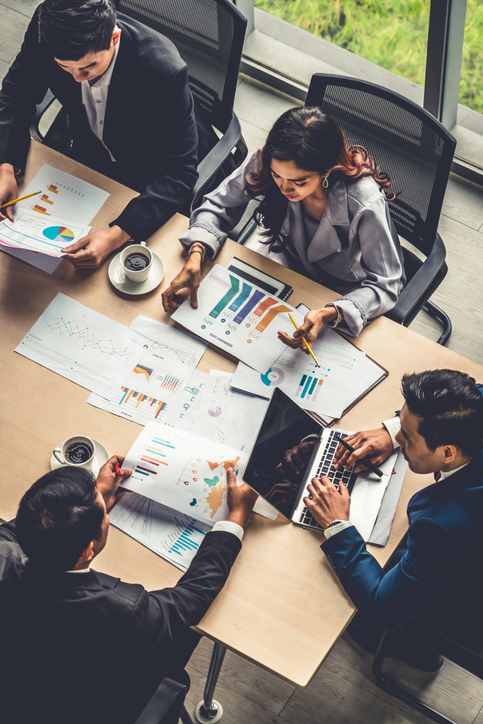A group of people looking into financial charts