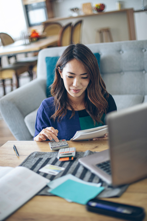 woman with a calculator and a laptop